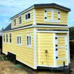 See How a 28′ Tiny House on Wheels Offers a Generous Bedroom Space Paired with a Smart Storage Loft