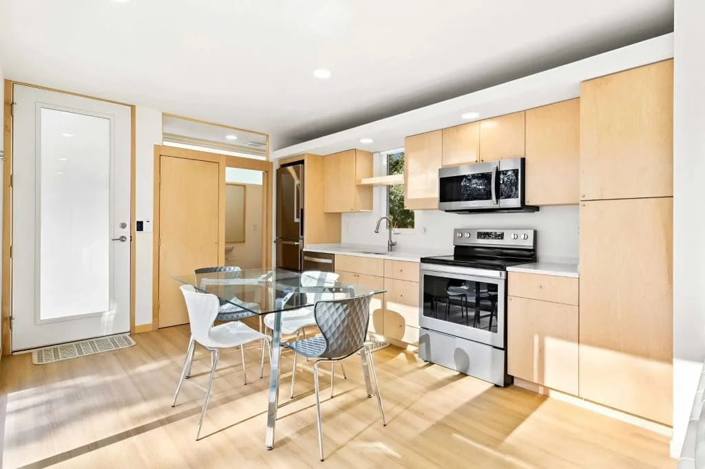Fully equipped kitchen with full-size stainless steel appliances and custom cabinetry